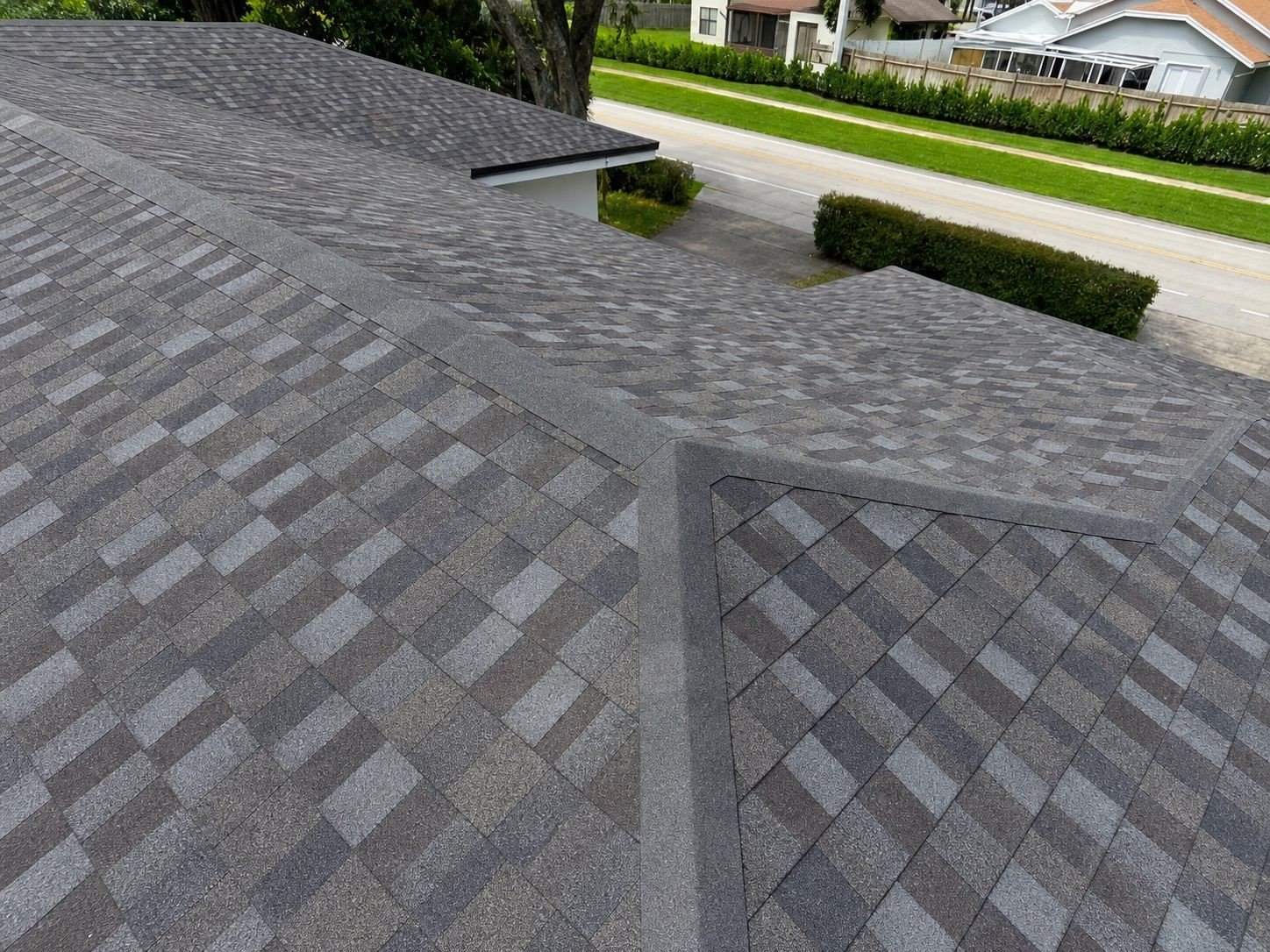 Close view of a finished shingle roof showing valley and ridge detailing